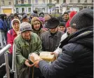  ?? EFREM LUKATSKY / AP ?? Residents stand in a bread line in Bakhmut, Ukraine, Friday. Ukrainians might soon be without power for four hours a day.