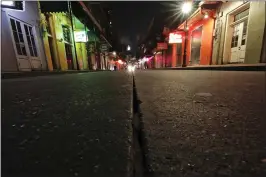  ?? GERALD HERBERT — THE ASSOCIATED PRESS ?? Bourbon Street, which is normally bustling with tourists and revelers in the French Quarter of New Orleans, was deserted on Thursday as bars and clubs were shuttered.