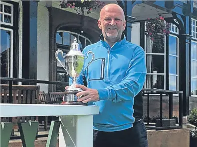  ??  ?? Graham Bell with the Scottish Seniors Men’s Open Championsh­ip silverware.