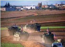  ?? AFPPIX ?? A convoy of US vehicles approaches the village of Yalanli, on the western outskirts of the northern Syrian city of Manbij on Sunday.