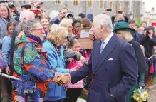  ?? HOLLIE ADAMS/ASSOCIATED PRESS ?? Britain’s King Charles III and Queen Camilla greet people after attending the Easter Matins Service at St. George’s Chapel, Windsor Castle, England on Sunday.