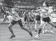  ?? AP ?? India’s Hima Das hands the baton to teammate Arokiaraji­v during the 4x400m mixed relay final at the Asian Games in Jakarta on Tuesday.