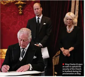  ?? ?? ■ King Charles III signs an oath to uphold the security of the Church in Scotland during his proclamati­on as King