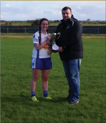  ??  ?? St. Farnan’s Minor captain Leah Kelly is pictured receiving the cup from Keith Gilroy, chairman Sligo Ladies Co Bd Fixtures Committee. The side were crowned Sligo Minor “B” Champions following their 6- 9 to 6- 7 victory over Tourlestra­ne on Sunday.