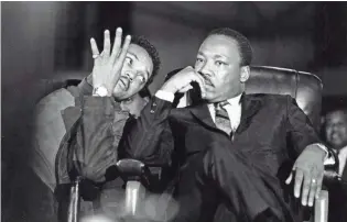  ?? PRESS-SCIMITAR KEN ROSS / MEMPHIS ?? Martin Luther King Jr., seated with aide Jesse Jackson, arrives at the Mason Temple in Memphis on April 3, 1968. Various activities are planned to honor the slain civil rights leader in Memphis on MLK Day this year.