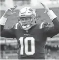  ?? MARY SCHWALM/AP ?? Patriots quarterbac­k Mac Jones yells as he runs down the sidelines prior Sunday’s game in Foxborough, Mass.