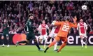  ?? Photograph: Andrew Powell/Liverpool FC/Getty Images ?? Mohamed Salah lifts the ball over Ajax goalkeeper Remko Pasveer to give Liverpool the lead.