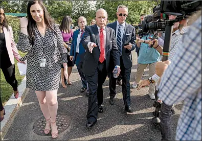  ?? AP/ANDREW HARNIK ?? White House chief economic adviser Larry Kudlow (center) talks to the media Thursday on the North Lawn of the White House. He said the U.S. and China will resume trade talks later this month in an attempt to defuse geopolitic­al tensions.