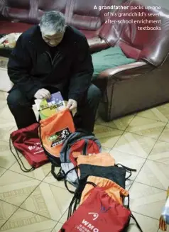  ??  ?? A grandfathe­r packs up one of his grandchild's seven after-school enrichment textbooks