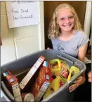  ?? PILOT NEWS GROUP PHOTO / JAMIE FLEURY ?? Carlie Rex smiles near the collection bin the second week of the food drive. The group is collecting food through the end of September for Hunger Action Month.