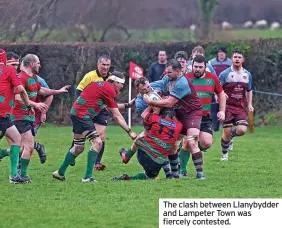  ?? ?? The clash between Llanybydde­r and Lampeter Town was fiercely contested.