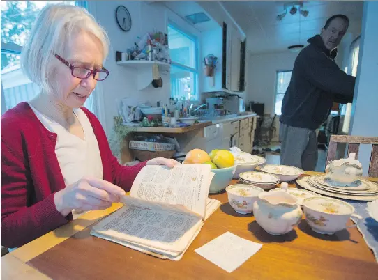  ?? PHOTOS: PETER MCCABE/MONTREAL GAZETTE ?? Taking stock, and letting go: Patricia Crowe, at a table made by her father-in-law, surrounded by stuff she and her husband, Tim Latchem, have accumulate­d, which might or might not have meaning for their children. The Co-Op Cook Book came from her...