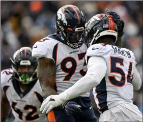  ?? AARON ONTIVEROZ — THE DENVER POST ?? The Broncos’ Jacob Martin, right, celebrates with teammate Dre’mont Jones after sacking Titans quarterbac­k Ryan Tannehill during the second quarter of their game Nov. 13 in Nashville, Tenn.