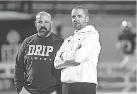  ?? PAUL KNIGHT/SPECIAL TO AMERICAN-STATESMAN ?? Vandegrift coach Drew Sanders, right, standing with Dripping Springs’ Galen Zimmerman before a game, has guided his team to 106 victories in the last 10 years.