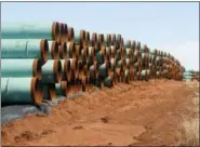  ?? SUE OGROCKI — ASSOCIATED PRESS FILE PHOTO ?? On Feb. 1, 2012, miles of pipe ready to become part of the Keystone Pipeline are stacked in a field near Ripley, Oklahoma.