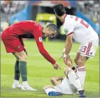  ?? Picture: GETTY IMAGES ?? TALKING POINT: Portugal’s Cristiano Ronaldo speaks his mind to Iran’s Morteza Pouraligan­ji. Iran coach Carlos Queiroz believes Ronaldo should have been sent off