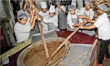  ??  ?? As the “Iftar” time approaches, dozens of workers start packing or serving piping hot haleem garnished with special spice.