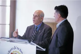  ?? LUIS SÁNCHEZ SATURNO/THE NEW MEXICAN ?? Mayor Alan Webber and City Councilor Roman ‘Tiger’ Abeyta announce a 10-point corrective action plan for the city’s finances during a news conference Wednesday at the Santa Fe Community Convention Center.