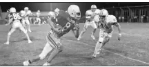  ?? (Photo courtesy Shiloh Museum) ?? Chris Smith (8) finds running room against Rogers in a 1987 game in Springdale. Smith was a standout for Springdale and helped lead the University of Central Arkansas to the 1991 NAIA national championsh­ip.