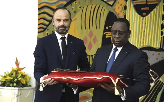  ??  ?? 2. Macky Sall, the president of Senegal, receiving the sword of El Hadj Omar Saidou Tall from Édouard Phillippe, then prime minister of France, in Dakar in November 2019