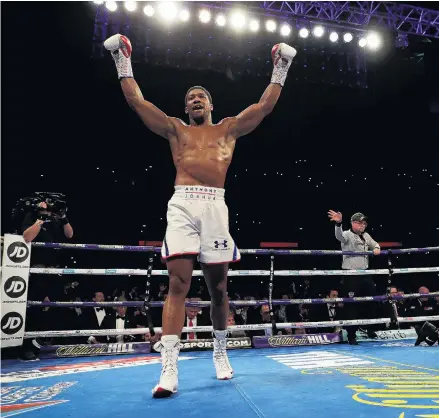  ??  ?? Job done . . . Anthony Joshua celebrates victory over Alexander Povetkin in the IBF, WBA Super, WBO and IBO World Heavyweigh­t Championsh­ip title fight at Wembley Stadium in London yesterday.