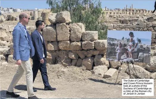  ??  ?? The Duke of Cambridge and Crown Prince Hussein look at a photo of the Duchess of Cambridge as a child, at the Roman city of Jerash in Jordan