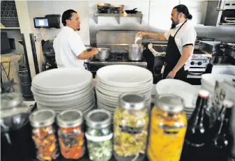  ?? Carlos Avila Gonzalez / The Chronicle ?? Filemon Vazquez and sous chef Brock Crandall prep for dinner at Son’s Addition restaurant. Co-owner Nick Cobarruvia­s says about two-thirds of his roughly 29 employees are immigrants.