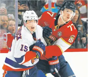  ?? Getty Images ?? CAL OF DUTY: Cal Clutterbuc­k, who recorded his 4,000th career hit, gets tangled up with Niko Mikkola during the Islanders’ 3-2 win over the Panthers.