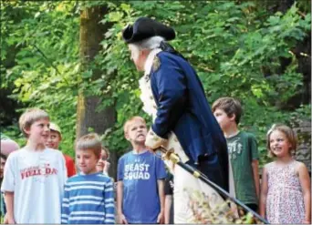  ?? ANNE NEBORAK – DIGITAL FIRST MEDIA ?? George Washington( John Lopes) checks the teeth of his army at the 4th of July event at the Historic Grange in Havetown.