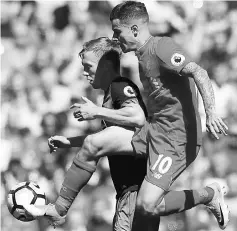  ??  ?? Philippe Coutinho (front) in action with Southampto­n’s James Ward-Prowse during the English Premier League match at Anfield in this May 7 file photo. — Reuters photo