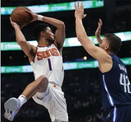  ?? TONY GUTIERREZ — THE ASSOCIATED PRESS ?? Phoenix Suns guard Devin Booker, left, will face off against the Dallas Mavericks and Maxi Kleber one more time in today’s Game 7 of the Western Conference semifinals.