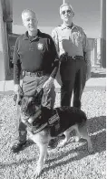  ?? DEBORAH FOX/NEWS-BULLETIN ?? Bo, a German shepherd therapy dog whose handler is Reserve Deputy Joseph Krcal, left, is the newest addition to the Valencia County Sheriff’s Office operations. Undersheri­ff Mark Shea, right, said it’s a first for the office.