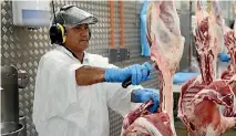  ?? CAMERON BURNELL/FAIRFAX NZ ?? A worker processes lamb for export to Iran.