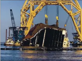  ?? ST. SIMONS SOUND INCIDENT RESPONSE PHOTO BY FARRELL LAFONT OF GALLAGHER MARINE SYSTEMS ?? A towering crane straddles the capsized cargo ship Golden Ray, its interior decks exposed after the ship’s bow was cut off and hauled away, off the coast of St. Simons Island, Ga.