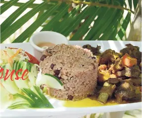  ??  ?? Indulge in one of the Island’s favourite dishes, curried goat with rice and peas.