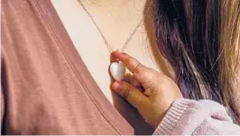  ?? KELSEY MCCLELLAN/THE NEW YORK TIMES ?? Alma Partida and her daughter, Alessa, in Watsonvill­e, California. Partida’s pendant is made from her breast milk. Mothers are memorializ­ing their breastfeed­ing experience­s with stones made from the liquid.