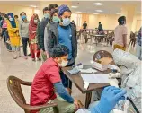  ?? — PTI ?? Indians who were airlifted from Hubei province of Wuhan, undergo screening at a quarantine facility set by up ITBP, at Chhawla area in New Delhi on Saturday.