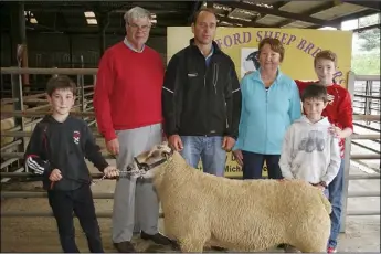  ??  ?? Back: Michael Brennan, secretary; Simon Browne, judge; June Harpur, chairperso­n; with Patrick and Tommy Rossiter and Aidan Boyle with the champion Charolais ram at the County Wexford Sheep Breeders annual show and sale in Enniscorth­y Mart.