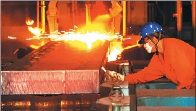  ?? LIU DEBIN / FOR CHINA DAILY ?? A worker operates a production line at a steel plant in Dalian, Liaoning province.