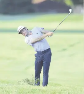  ??  ?? Doc Reman of the United States plays a shot on the 11th hole during the first round of the Rocket Mortgage Classic at the Detroit Golf Club in Detroit, Michigan. - AFP photo