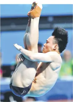  ??  ?? Xie competes in the men’s 3m springboar­d final. — Reuters photo