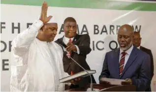  ??  ?? DAKAR: Adama Barrow (left) is sworn in as president of Gambia at Gambia’s embassy in Senegal on Thursday. — AP