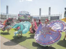  ?? JEFF HAYNES/AP ?? Members of the Ballet Folklorico Mexico Lindo perform in celebratio­n of Cinco de Mayo before a May 5, 2019, game between the Red Sox and White Sox in Chicago.