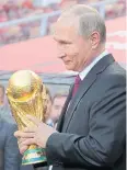  ?? AP ?? Russian President Vladimir Putin holds the Fifa World Cup trophy.