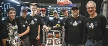  ?? Julian Gavaghan ?? Woodland Christian High School students Jack Good, Adrian Stan, Joseph Schuurman, Zack Scherer, Eli Sullivan, Zen Qu and mentors Steve Van Dokkumburg and Maurice Veldhuis with their robot.