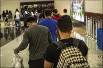  ?? AJC FILE 2021 ?? A group of volunteers has helped immigrants navigate Hartsfield­Jackson Internatio­nal Airport since 2020. They are not part of a traffickin­g network, as state Sen. Colton Moore alleged. He also said the military was guarding the migrants, which was false.