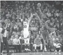  ?? GETTY IMAGES ?? Golden State’s Stephen Curry shoots over Phoenix’s Isaiah Canaan on Monday night in Oakland, Calif.