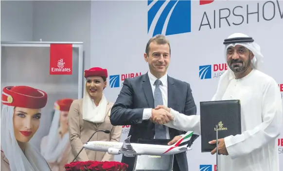  ?? Leslie Pableo for the National ?? Sheikh Ahmed bin Saeed, chairman of Emirates, signs the order for 50 A350-900 aircraft with Guillaume Faury of Airbus in Dubai yesterday
