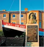  ??  ?? A statue and memorial to Henry Blogg in front of a restored portion of his fishing boat, the Q J & J, outside North Lodge, Cromer.