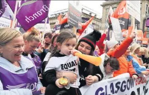  ??  ?? CHILD SUPPORT Little Lorrie Milne, above left, outside Glasgow’s City Chambers last month during a rally by 8000 GMB and Unison members, above, over an equal pay claim